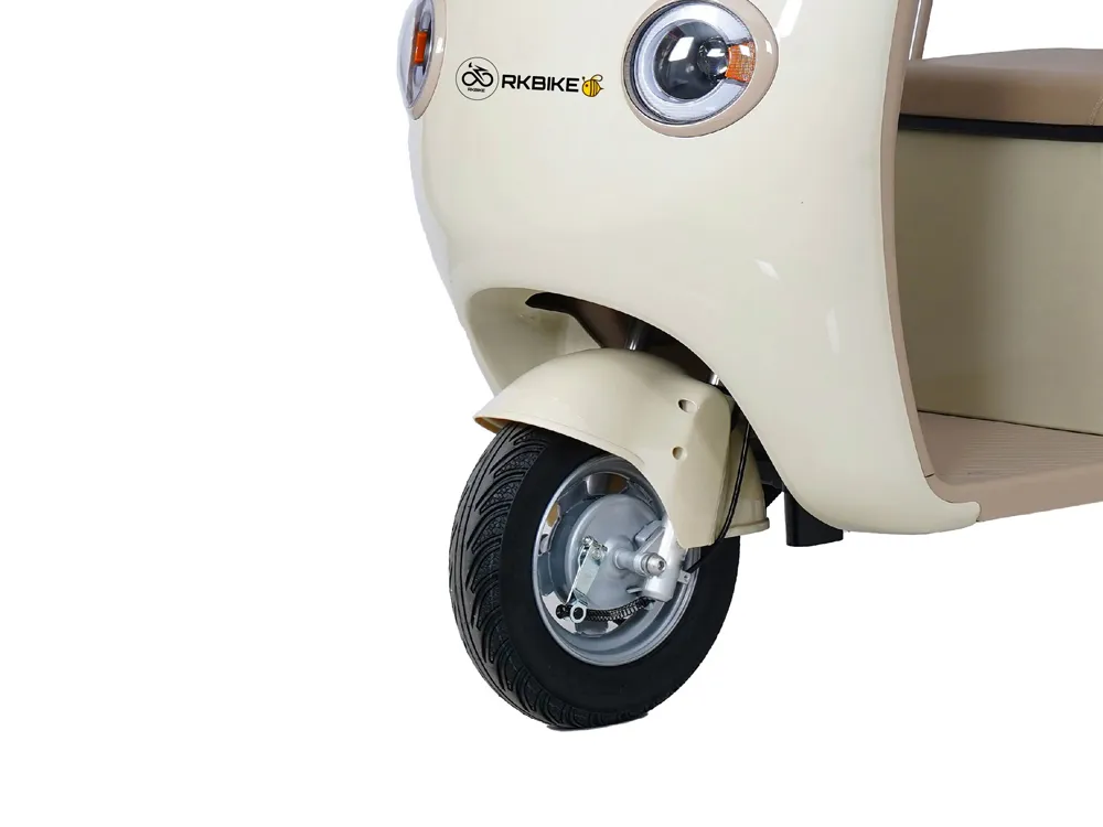 Close-up of the front wheel of an electric convertible tricycle, highlighting the durable tire, suspension system, and braking components for enhanced stability and safety