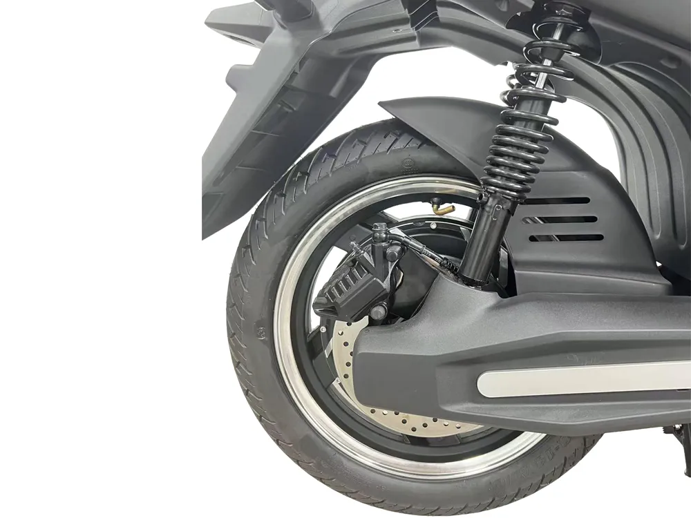 Close-up of electric scooter rear wheel showing alloy rim, rear tire, hub motor, and rear suspension