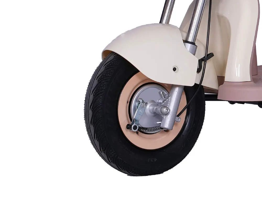 Close-up of the front wheel of a cream white electric tricycle, highlighting durable tire material, stable three-wheel design, and smooth steering for safe urban commuting