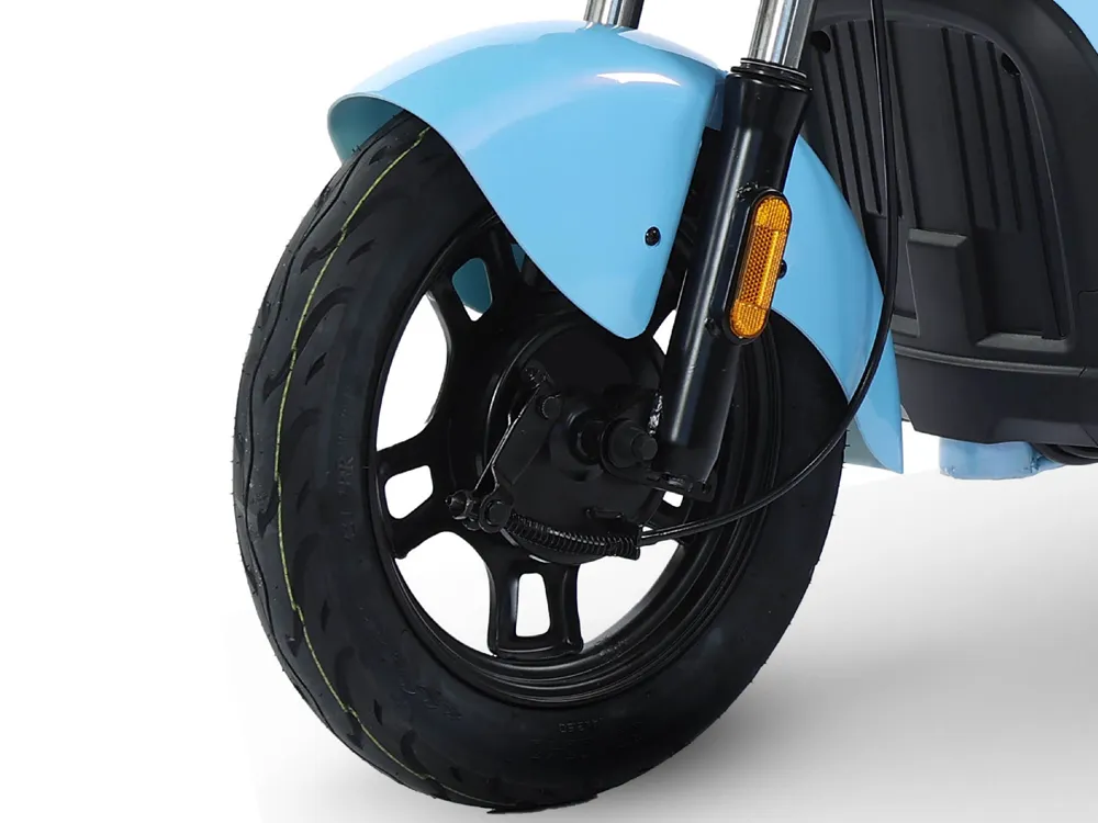 Close-up of electric scooter front wheel showing tire tread, disc brake, and hub design for urban commuting