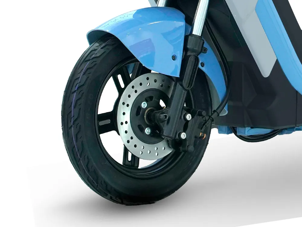 Close-up of blue electric scooter front wheel showing tire tread, disc brake, and hub design for stable and safe urban commuting