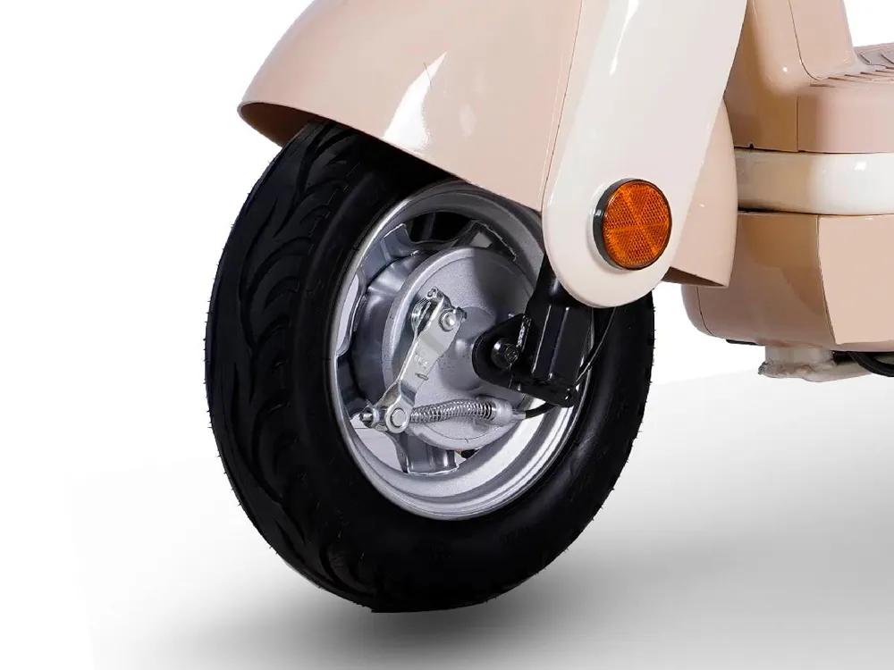 Close-up of a beige electric scooter’s front wheel, showing the tire tread, disc brake, and hub design for stable and safe urban commuting
